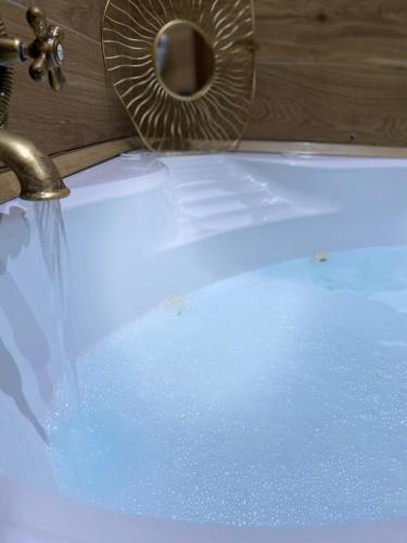 a bathroom sink with water coming out of a faucet at Suite room in Aversa