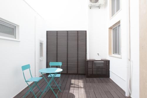 a small table and two chairs on a balcony at AC Home in Novoli
