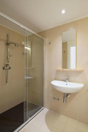 a bathroom with a sink and a shower at Vallesinella Hotel Restaurant Bar in Madonna di Campiglio