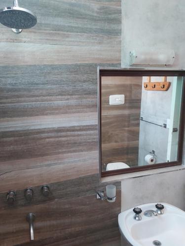 a bathroom with a sink and a mirror at Chapadmalal Casas La Bella in Colonia Chapadmalal