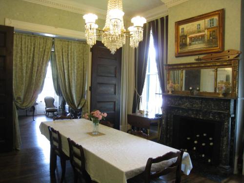 a dining room with a table and a fireplace at Allegheny Street Bed & Breakfast in Hollidaysburg