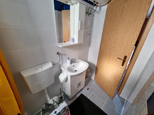 a small bathroom with a toilet and a sink at City Break Apartment in Zagreb