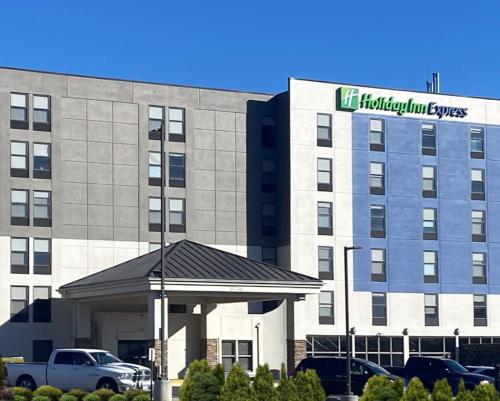 a hotel building with a sign on the front of it at Holiday Inn Express & Suites Central Omaha by IHG in Omaha