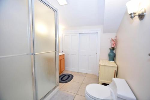 a bathroom with a toilet and a glass shower at Crab Cove On The Bay 406 in Ocean City