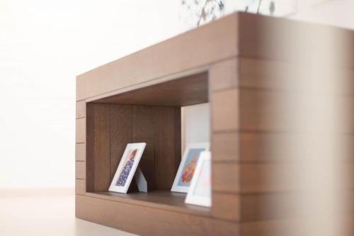 a wooden shelf with two pictures on it at AC Home in Novoli
