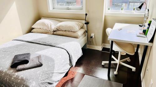 a bedroom with a bed and a desk at Home in Downtown in Toronto
