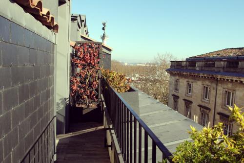 a balcony of a building with red leaves on it at Hôtel de Sèze & Spa Bordeaux Centre in Bordeaux