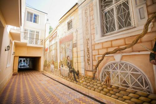 a hallway with a mural on the side of a building at Premier Geneva Hotel in Odesa