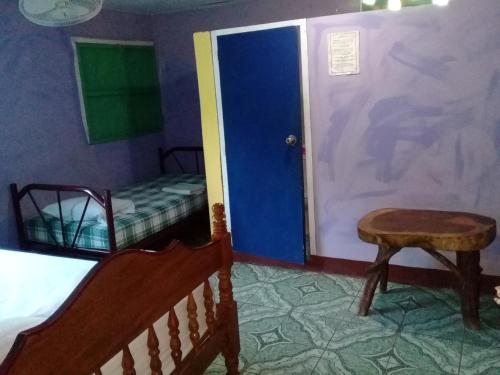 a bedroom with a bed and a table and a door at Hostal Maria in Rivas