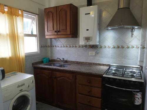 a kitchen with a sink and a stove at Chapadmalal Casas La Bella in Colonia Chapadmalal