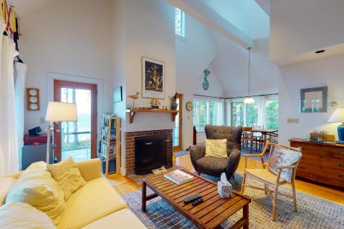 a living room with a couch and a fireplace at Driftwood in Glenmere