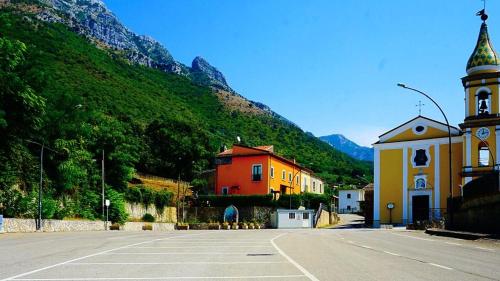 an empty street with a church and a mountain at Affittacamere Il Colle in Faicchio