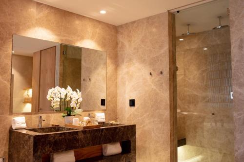 a bathroom with a sink and a shower at Secrets Bahia Mita Surf and Spa - All Inclusive - Adults Only in Punta Mita