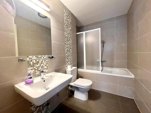 a bathroom with a sink and a toilet and a tub at Lavender Bay Apartment C23 in Kotor