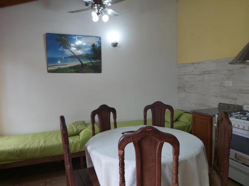 a dining room with a table and a couch at Chapadmalal Casas La Bella in Colonia Chapadmalal