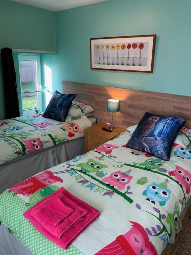 a bedroom with two beds with towels on them at Bedrock Lodge in Bristol