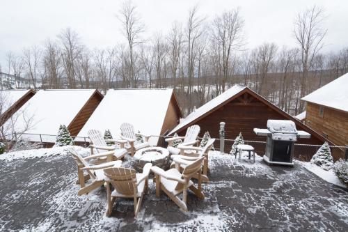 a group of chairs and a grill in the snow at The Lodges at Sunset Village in McHenry