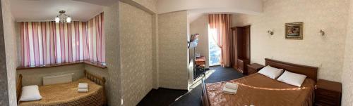 a hotel room with two beds in a room at Golden Lion Hotel in Boryspilʼ