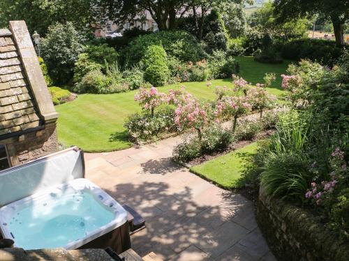 a bath tub in a yard with a garden at Manor House in Accrington