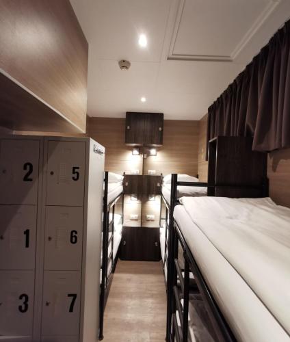 a room with two bunk beds and lockers in it at Hotel Jesse in Amsterdam