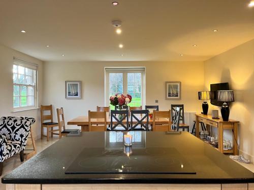 a kitchen and dining room with a table and chairs at The Lough Erne House at Golf Village Lough Erne Resort in Enniskillen