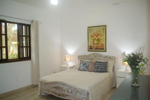 Tempat tidur dalam kamar di Casa das Orquídeas