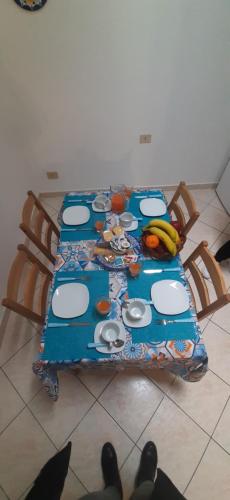 a table with a blue table cloth on it at La terra del sole in Cinisi