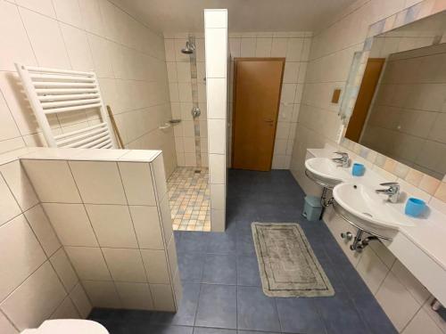 a bathroom with a sink and a toilet and a mirror at Wonder & Wander in Ehrwald