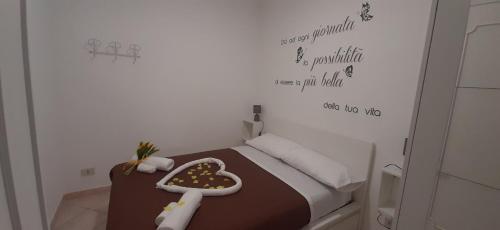 a small bedroom with a bed with a brown blanket at La terra del sole in Cinisi