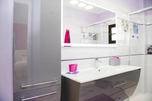a white bathroom with a sink and a mirror at Apartment, Los Llanos de Aridane in Los Llanos de Aridane