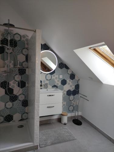 a bathroom with a sink and a mirror at La maison de Joëlle in Châteauvieux