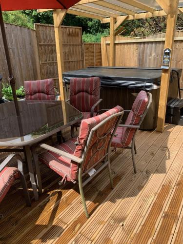 a patio with a table and chairs and a pool at Bedrock Lodge in Bristol
