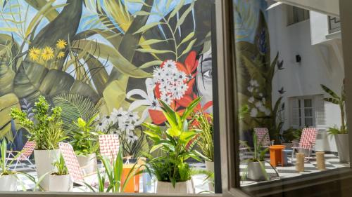 a room with many potted plants on a table at Selina Salta in Salta