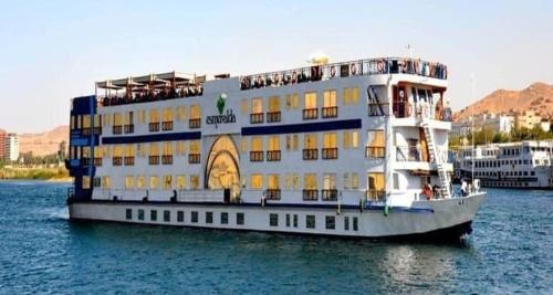 a large boat in the water with a building at One Love Guesthouse & Restaurant in Luxor