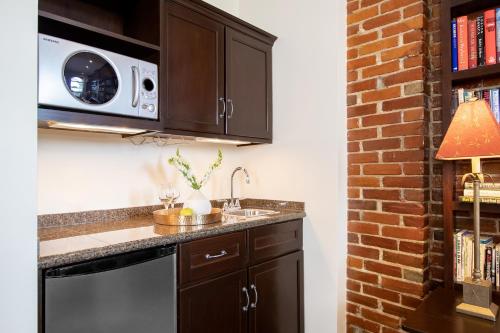 a kitchen with a sink and a microwave at Retro Suites Hotel in Chatham