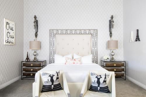 a bedroom with a large white bed with two night stands at Retro Suites Hotel in Chatham
