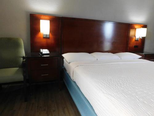 a hotel room with a bed and a telephone at Park View Inn. in Greensboro