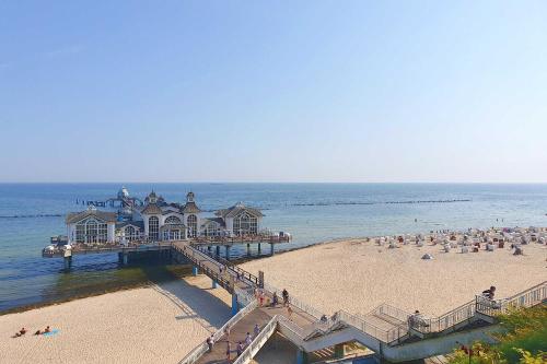 a pier with a group of people on the beach at Villa Stoertebeker Apartment 19 in Baabe