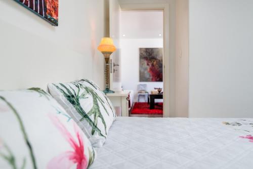 a bedroom with a bed with pillows at Tilias Apartment at Estoril in Estoril