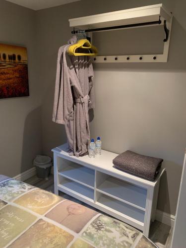 a room with a bed and a shelf with clothes at Bedrock Lodge in Bristol