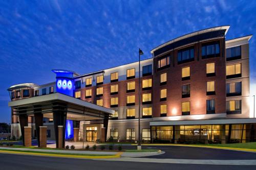a large building with a clock on the front of it at Hotel Indigo Atlanta Airport College Park, an IHG Hotel in Atlanta