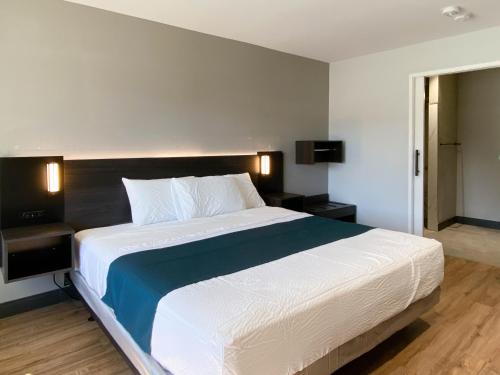 a bedroom with a large bed in a room at Studio 6 Suites Stockton, CA Waterfront in Stockton