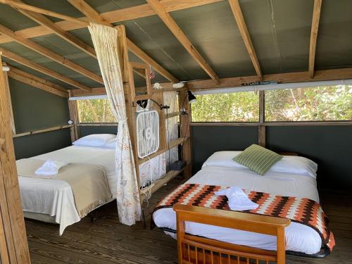 a room with two beds in a cabin at Virgin Islands Campground in Water Island