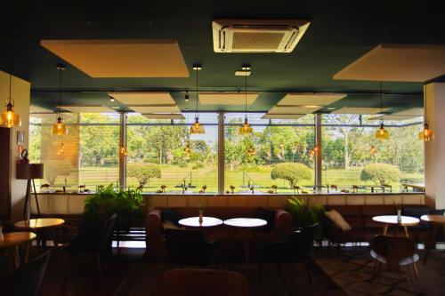 a restaurant with tables and chairs and a large window at Borgen Hotel in Castro