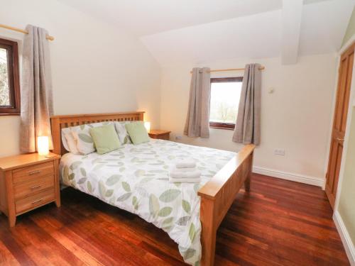 a bedroom with a large bed and a window at Horse Mill Lodge in Taddington