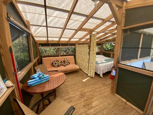 an inside view of a tiny house with a table and a bed at Virgin Islands Campground in Water Island