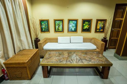 a room with a couch and a table with pillows at Lost Paradise Resort in Batu Ferringhi