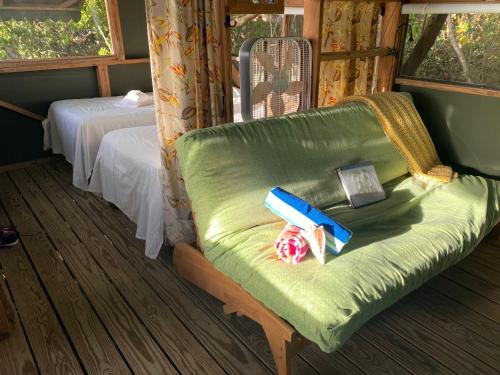 a room with a green chair with a box on it at Virgin Islands Campground in Water Island