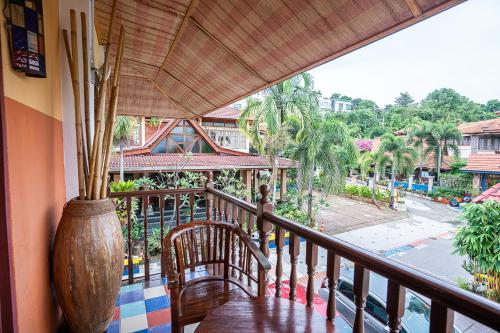 a balcony with a table and a view of a street at Lost Paradise Resort in Batu Ferringhi