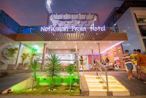 a group of people standing outside of a hotel at Netuanah Praia Hotel in João Pessoa